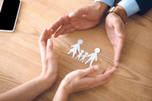 Family Law Lawyer Rockville, MD- lawyer and clietns hands circling cutouts of family