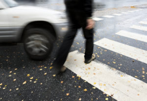 Pedestrian Accident Lawyer Washington, DC with a man crossing a road with a car approaching