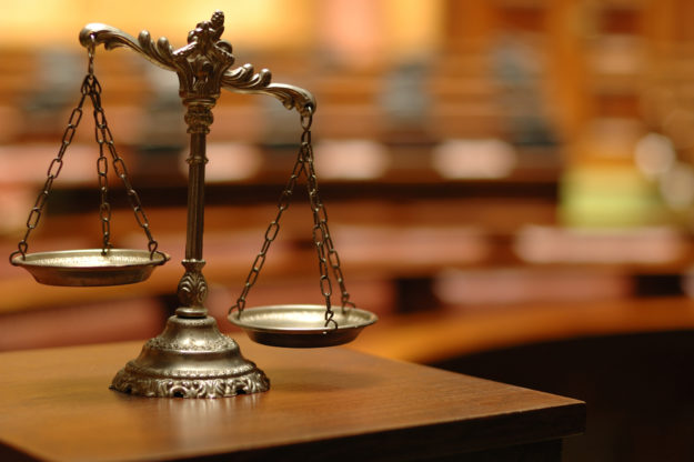 The Civil Litigation Discovery Process - Decorative Scales of Justice in the Courtroom