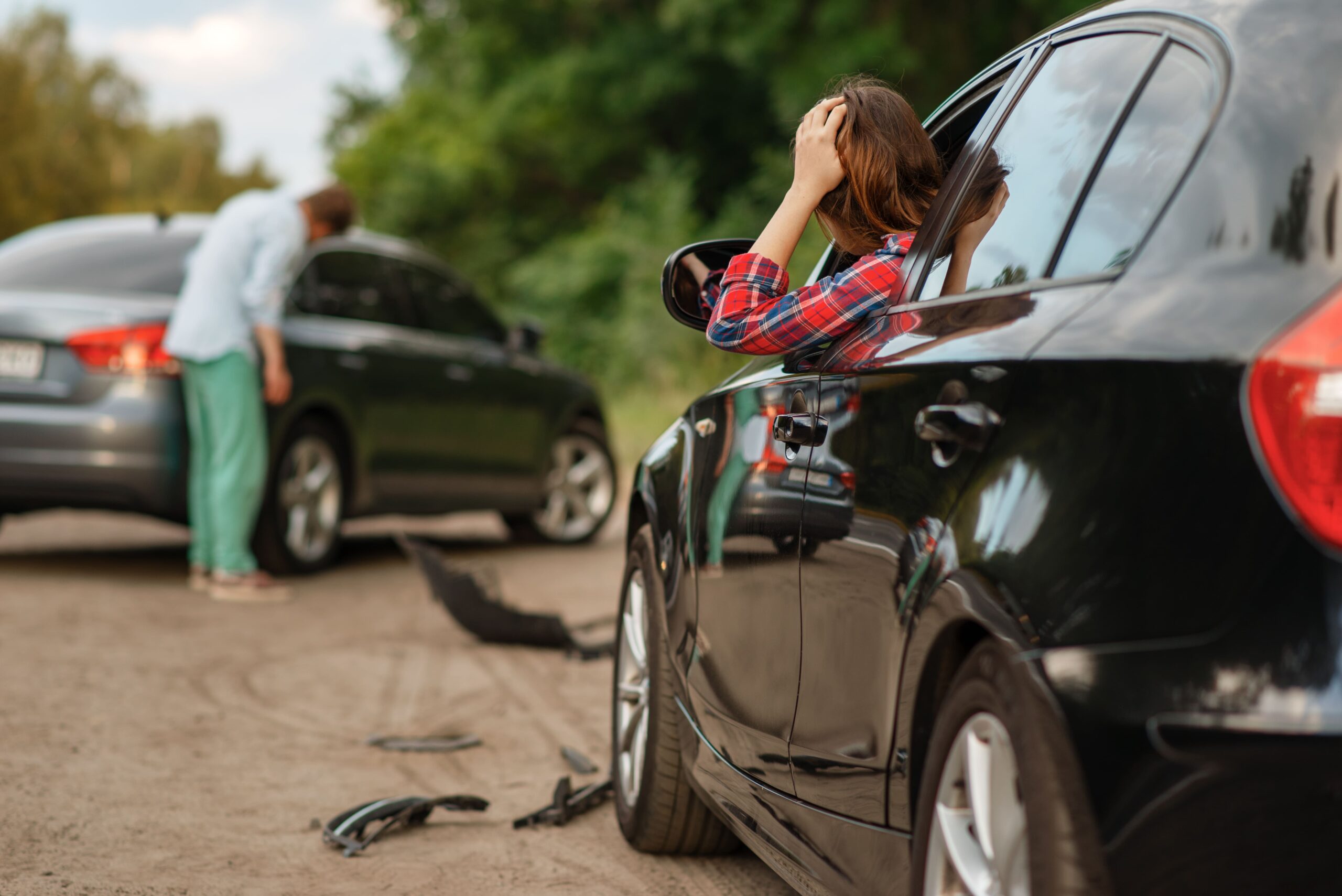 car accident lawyer with a woman holding her head after a car accident